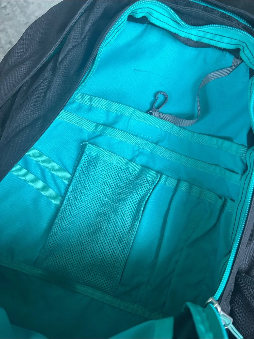 The North Face Black Backpack with Teal Trim and Bungee